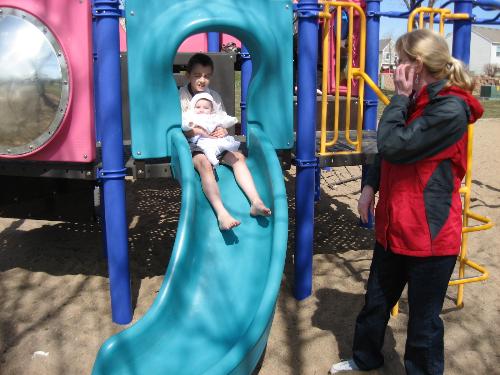 Grandkids - Tyler taking Savanna down the slide Easter Sunday 2009.