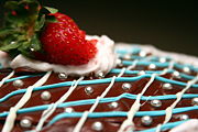 Cakes and more - A finished cake is often enhanced by covering it with icing, or frosting, and toppings such as sprinkles, which are also known as 'jimmies' in certain parts of the United States and 'hundreds and thousands' in the United Kingdom. Frosting is usually made from powdered (icing) sugar, sometimes a fat of some sort, milk or cream, and often flavorings such as vanilla extract or cocoa powder. Some decorators use a rolled fondant icing. Commercial bakeries tend to use lard for the fat, and often whip the lard to introduce air bubbles. This makes the icing light and spreadable. Home bakers either use lard, butter, margarine or some combination thereof. Sprinkles are small firm pieces of sugar and oils that are colored with food coloring. In the late 20th century, new cake decorating products became available to the public. These include several specialized sprinkles and even methods to print pictures and transfer the image onto a cake.