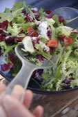 salad - Preparing fresh salad: mixing everything in the salad bowl