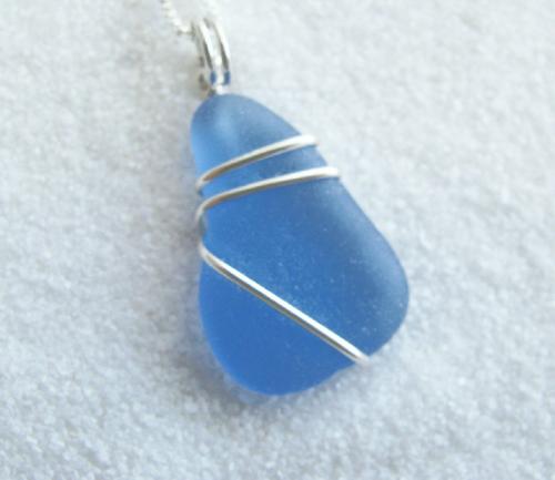 Cornflower Blue Sea Glass Necklace - This gorgeous piece of cornflower blue sea glass is wrapped with sterling silver wire, and dangles from an 18' sterling silver chain.  Cornflower blue sea glass is considered to fall in the rare color category and this weathered, beautifully smoothed piece is practically flawless!