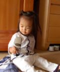 texting - shows a child using a cell phone and symoblizes how everyone is caught up in texting.
