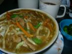 lomi - shows a native dish of the philippines featuring noodles with light sauce and chicken or beef.