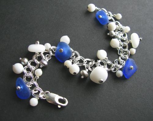 White Caps Sea Glass Bracelet Cobalt and Milk Glas - This 7' sterling silver bracelet is adorned with 7 pieces of authentic sea glass- 3 pieces of opaque white (also known as milk glass) and 4 pieces of cobalt blue. The sea glass is accented with polished mother of pearl shell beads and silver blue fresh water pearls.