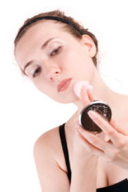 Applying Makeup - Girl applying makeup from a compact.