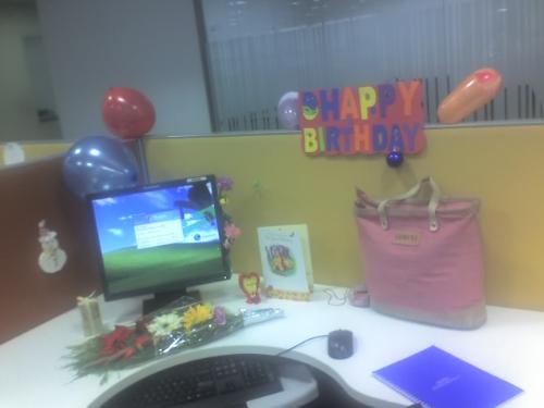 MY desk at office on my birthday! - This picture was taken on my birthday in office.
All my colleagues decorated my desk with post-its and balloons and flowers.
It looked very colourful and perky!