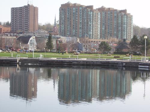 Kempenfelt Bay in Barrie Ontario in Canada - The waters were smooth as glass reflecting the city front.  I thought it was a gorgeous shot.  Steady hands an no wind at all :))  I love photography :))