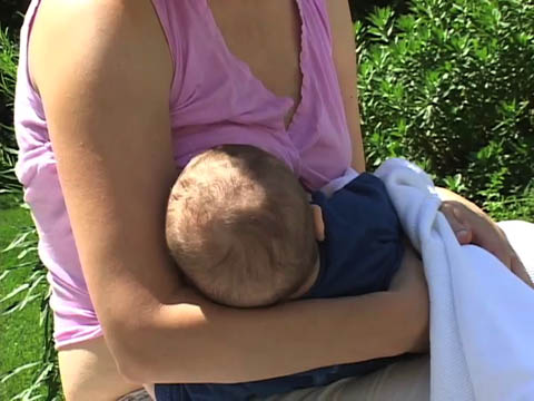 Breast Feeding In Public - A woman breast feeding in public