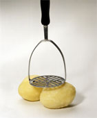 potatoes - Two Cooked and Peeled Potatoes with Masher