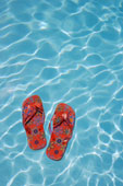 Pool - Flip-flops floating in swimming pool