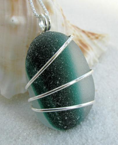 Emerald Splash Sea Glass necklace - This frosty piece of sea glass has an two-toned emerald and dark green 'splash' of color in the center of the glass. This multi-color piece is also known as 'end of day glass' and it was found on the northern shores of the United Kingdom. The perfectly rounded piece of glass is approx 1 1/8'L, is wrapped with sterling silver wire and hangs on an 18' Venetain box style sterling silver chain.