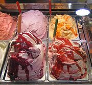 Ice Cream - Ice cream is a traditional dessert in Italy. Much is still hand-made by individual gelateria in 'produzione propria' ice cream shops. Italian ice cream or gelato is made from whole milk, eggs, sugar, and natural flavorings. Gelato typically contains 7-8% fat, less than ice cream's minimum of 10%.  Before the cone became popular for serving ice cream, in English speaking countries, Italian street vendors would serve the ice cream in a small glass dish referred to as a 'penny lick' or wrapped in waxed paper and known as a hokey-pokey (possibly a corruption of the Italian 'ecco un poco' - 'here is a little').  Some of the most known ice cream machine makers are Italian companies Carpigiani, Crm-Telme, Corema-Telme, Technogel, Cattabriga, Matrix, and Promag.