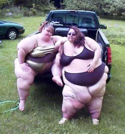 Now here's what you get for unlimited snacks! - A truly scary image--two hugely obese women on the back of a pickup truck. This visage is enough to scare anyone (and to think that anyone would allow themselves to look like this!) is a great advertisement for those unscrupulous diet pills. I am grateful that no politician would ever consider unlimited snacks as part of their political campaign--otherwise this would be a much more common sight during the summer!