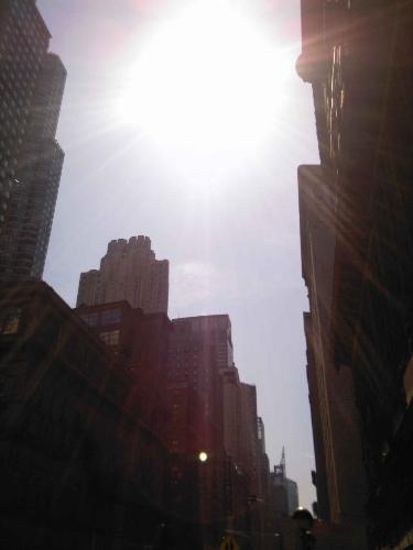 shining sun - sun shining over the tops of buildings