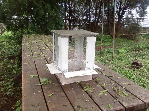 Custom Chimney Cap - Having a need to keep the local Squirrels out of my Chimney this will also relieve my concerns about the occasional bird that might also decide to nest in the opening that must not get closed off. This Chimney Cap sits upon a picnic table that is 14' long also a custom creation of my own handy work.