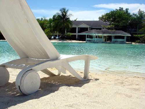 This Summer Destination is Waiting For You - This chair needs you to be there and enjoy the scenery and dip in the cool green water.