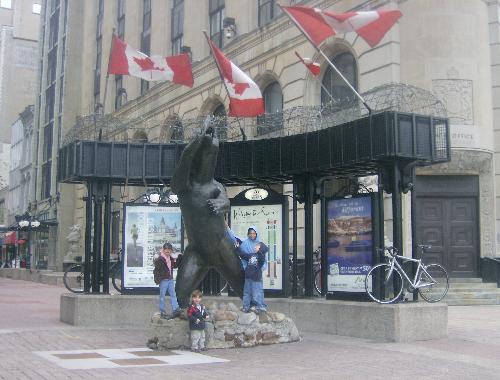 Kids posing with a statue in Ottawa - My 4 older kids posing with a bear statue in front of Sparks Street Mall in Ottawa.