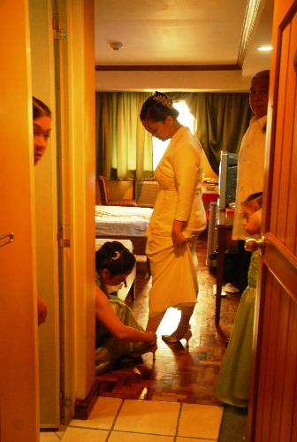Bride's wearing her shoes - The bride was assited by her Matron of Honor in fitting her shoes.