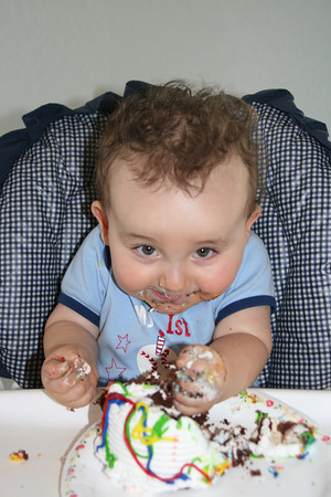 Liam's first birthday party - My great nephew eating cake on his first birthday. He now has a new cousin that was born today!