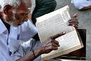 Holy Book - an old with poor eyesight try to read a holy book