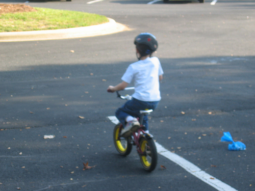 Boy riding a bike for the first time - Bike riding minus training wheels