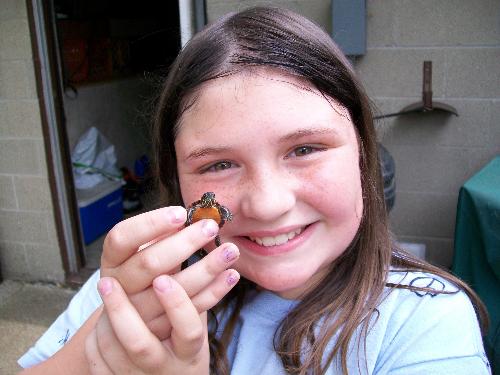 my youngest daughter with a turtle she caught - She finally caught a baby turtle. When she let it go she was sad but wanted it to grow up and be big when we visited again