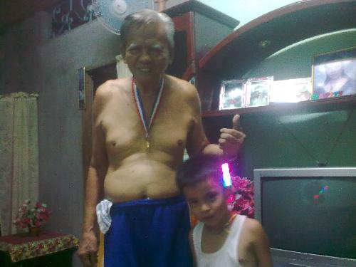 Grandpa and my little cousin - This picture was taken when my cousin(we call him 'Wewen') graduated in day care(1st level of education in the Philippines).. He was also the top9 of his class..