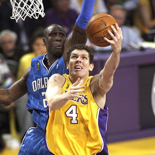 Lakers VS Magic Game 1 - Luke Walton goes for a layup as Michael Pietrus closes in from behind.