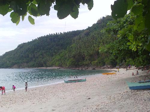 beach side at samal island, philippines - a very nice place to move away from the noise and pollution of the city. just two hours away from my home. but you have to trek for 30 minutes passing around 300 steps manmade stairs. its not totally developed yet .. no electricity .. hence a wonderful place to make a bonfire and sleep on a makeshift tent on the sand. this is where i encountered dolphins one time with the residents, that were washed ashore and needed to be helped back to sea.