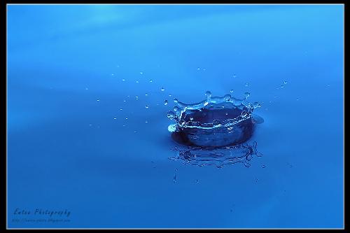 water droplet - a drop of water splashing into more water.