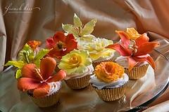 great cupcake giveaways - Here are cupcakes with various flower icing designs. Cheap and great for wedding giveaways to remind them of the sweet memorable day they had just attended.