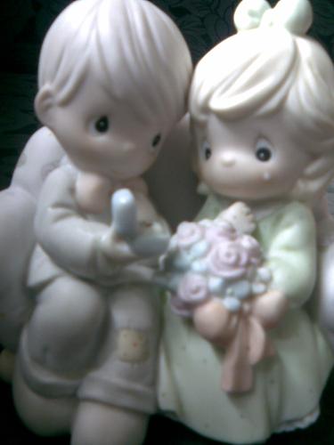 wedding photo - a picture of miniature model of two people getting married.