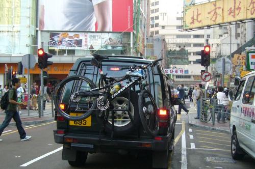 car - This is in HK as well. It was cool that this jeep has a bike with it.