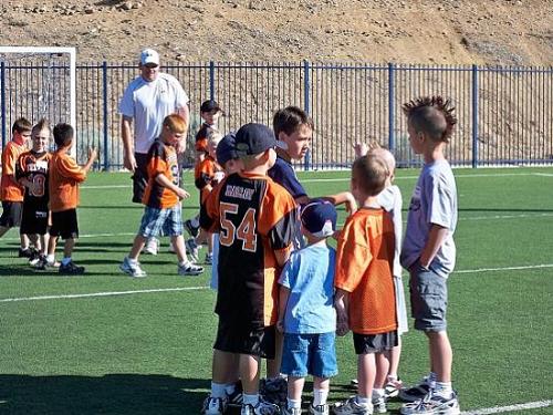 The 'huddle' during a quick game before football c - The 'huddle' during a quick game before football camp started. They even let the 3 year old play!