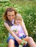 Child with mother - A little girl sitting in mother's lap