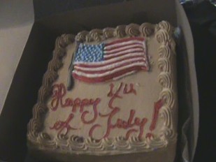 Our 4th Of July Cake! - Yummy. This is our 4th Of July cake. It was absolutely delcious. We got it from a nice little bakery around the corner. It was a white cake with custard filling, and mocha icing. YUMMY!