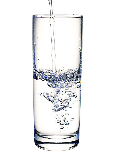 glass of water - water is getting poured into a glass