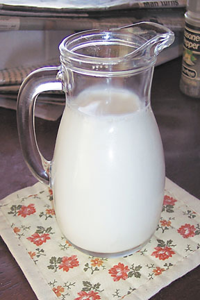 milk jug - container of milk sitting on a table