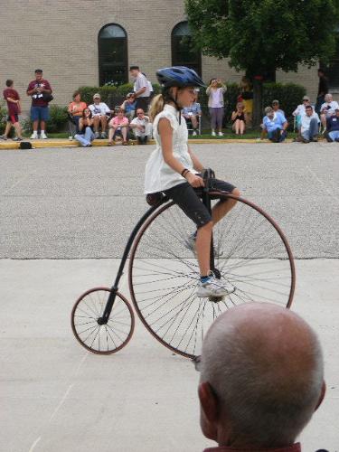 Little Girl on Antique Bicycle at Wheelmen Event - This little girl rode very well on this big-wheeled antique bicycle during a show at the National Wheelmen event held at Saint Mary-of-the-Woods, IN, on July 10, 2009.