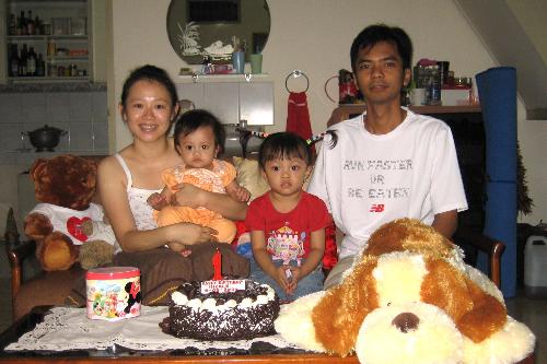 2nd 1st Birthday - Me and my second and my first daughter and my husband. It was a simple celebration. A cake and a candle for something to be remembered someday.