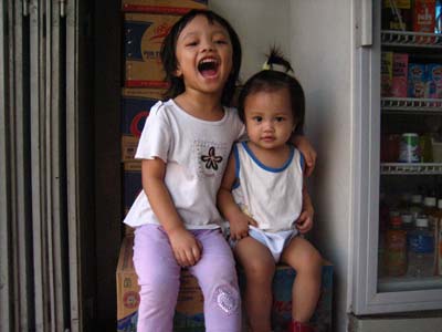 my 2 daughters - This evening when they were playing at the shop, Lou just sit on the mineral water carton box. Nic just slowly came to her and wanted to sit beside her too. It was very cute and touching moment for me. To know that this little creature though not being able to communicate well can show her will and curiosity.