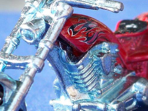 Macro Photography - This photo of a mini toy motorcycle is a prime example of Macro Photography. Macro Photography is a style of photography that is meant to show you a completely different view or a (close-up)of something that you would not normally notice in an object or photo, such as details etc.