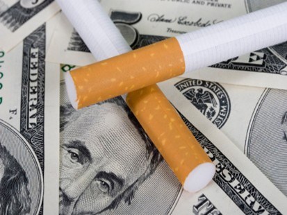 cigarettes and money - some cigarettes and money, indicating the taxes on those smokes