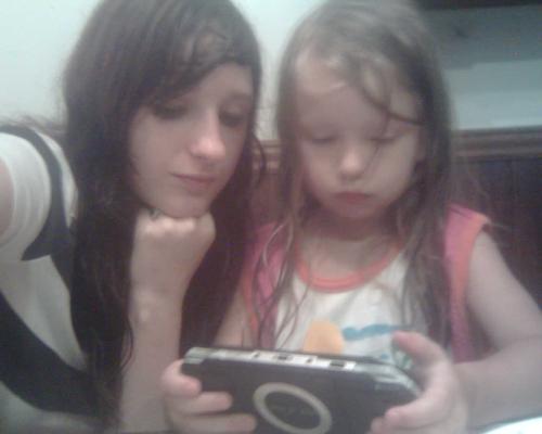 Me and baby cousin - PLaying PSP. She wanted to'play car' and needed me to back the car out of whatever trap she has set on it. (Mainly she just runs into buildings and can not reverse so i have to help her.) She is so adorable and she grows up so fast!!