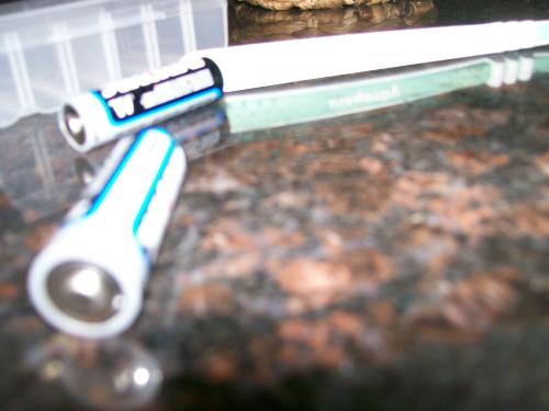 batteries - two double a batteries on a granite counter top