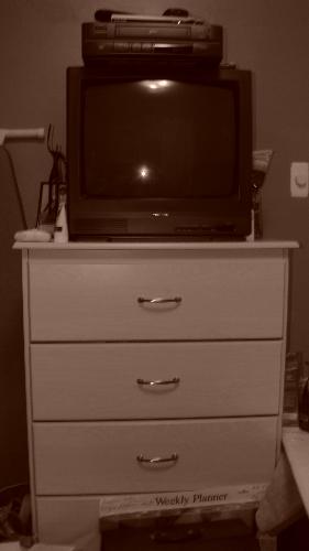 Old TV and VCR set - Old TV and VCR set sitting on top of a dresser in a sepia colored photo
