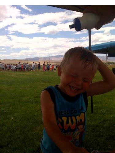 My three year old son staying cool in the sun with - My three year old son staying cool in the sun with a water bottle