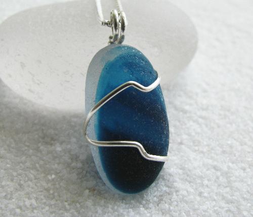 Ocean Waves Blue Multi Colored Sea Glass Necklace - A gorgeous multi-colored blue end of day piece of sea glass found on the Northern coast of England, is wrapped in sterling silver wire and dangles from an 18' Venetian box-style sterling silver necklace.