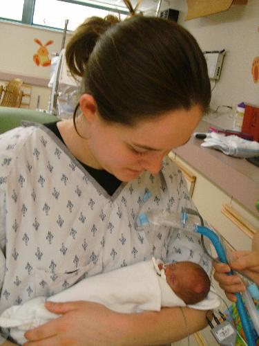 first time holding my new baby - My baby was born 16 weeks early. He has been in the hospital for 3 months. This is a picture of the first time I ever got to hold him when he was a month old. It was an amazing feeling to hold him.