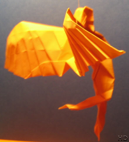 An Angel - An orange angel flying in the air - made by paper.