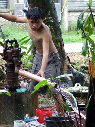 pump your water from the ground - Here's is the photo supposedly attached with my discussion with the same subject topic. There's my step-son who pumps water from the ground. This jet pump is connected to the well.